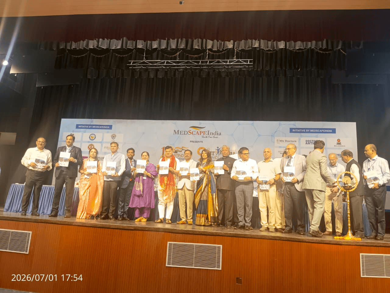 Group of attendees standing on stage at an academic event